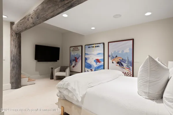 a spacious bedroom with a bed and a large window