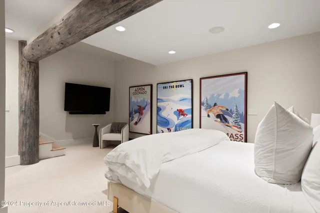 a spacious bedroom with a bed and a large window