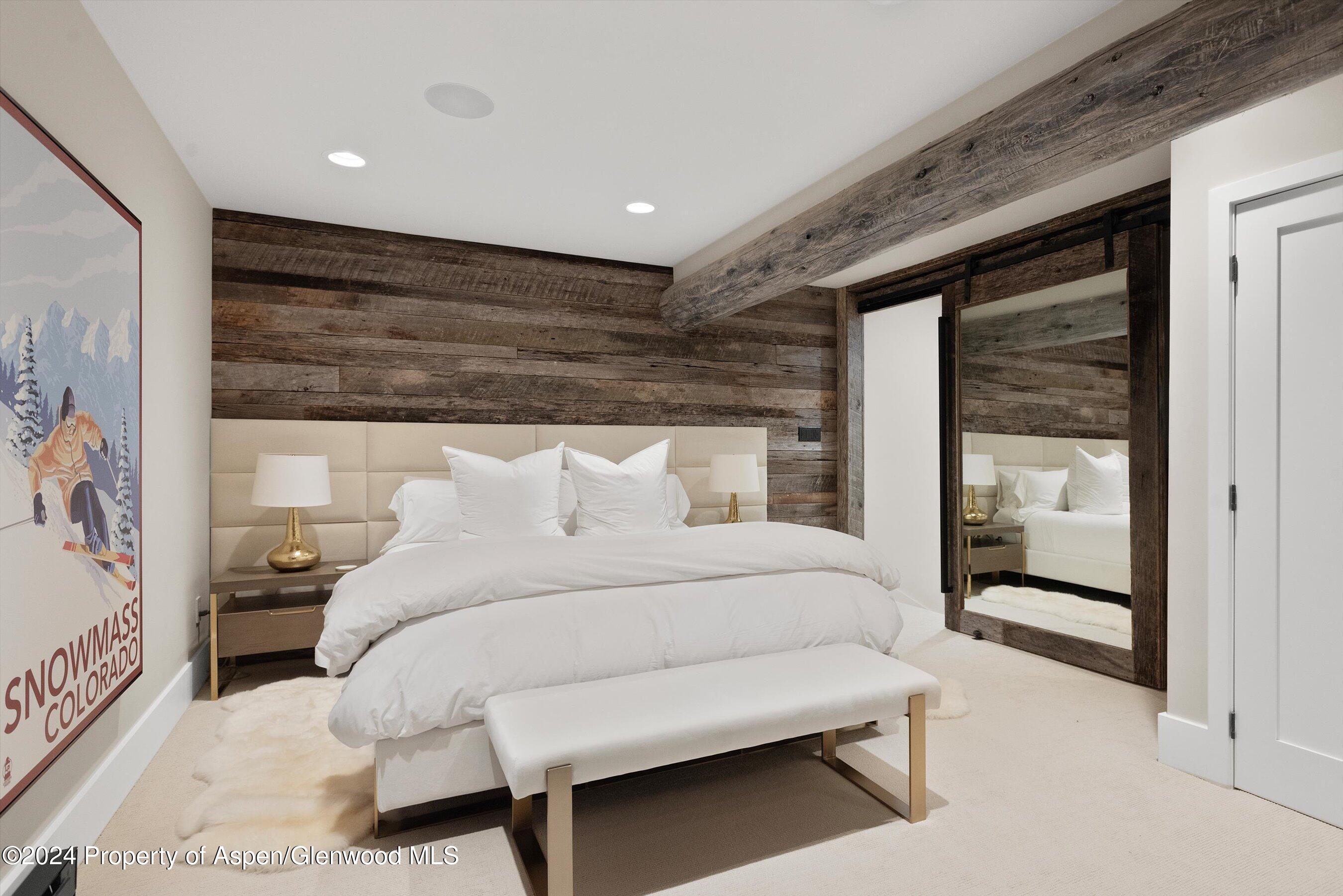 234 Bridge Lane Snowmass Village, CO 81615 - Photo 27 of 46 a spacious bedroom with a bed and a large window