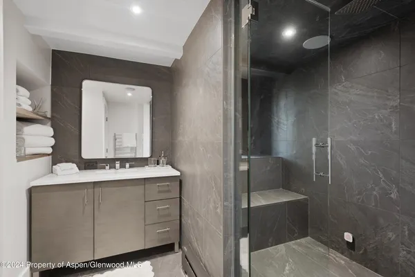 a balcony with couple of couches and potted plants