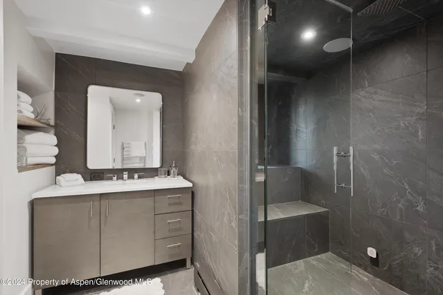 a balcony with couple of couches and potted plants