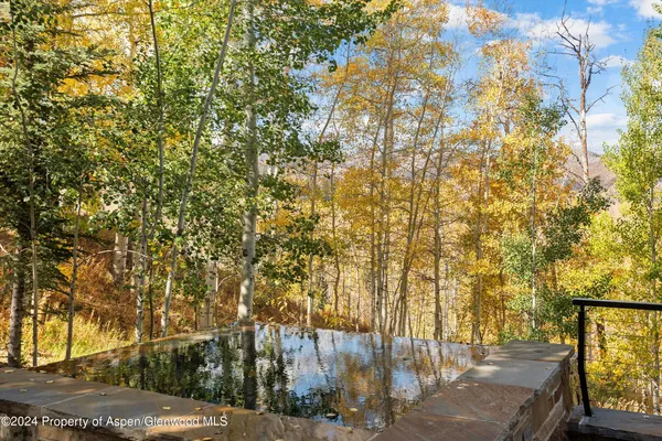 a view of balcony with two chairs and a table