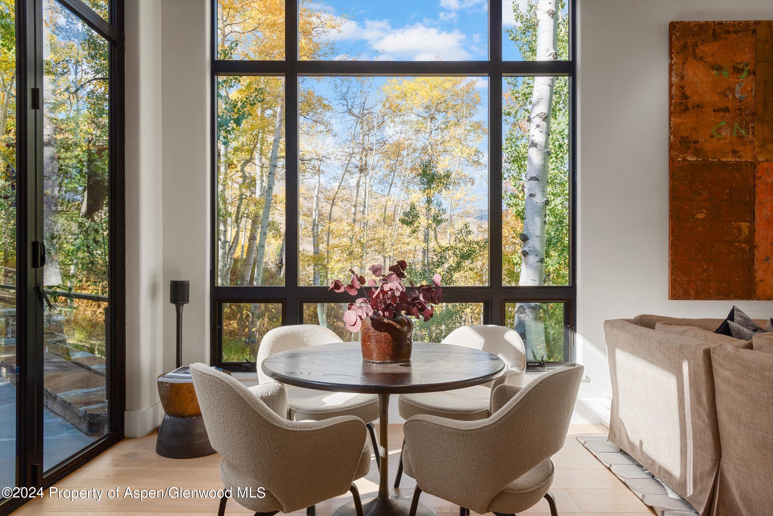 234 Bridge Lane Snowmass Village, CO 81615 - Photo 5 of 46 a dining room with furniture a chandelier and glass door
