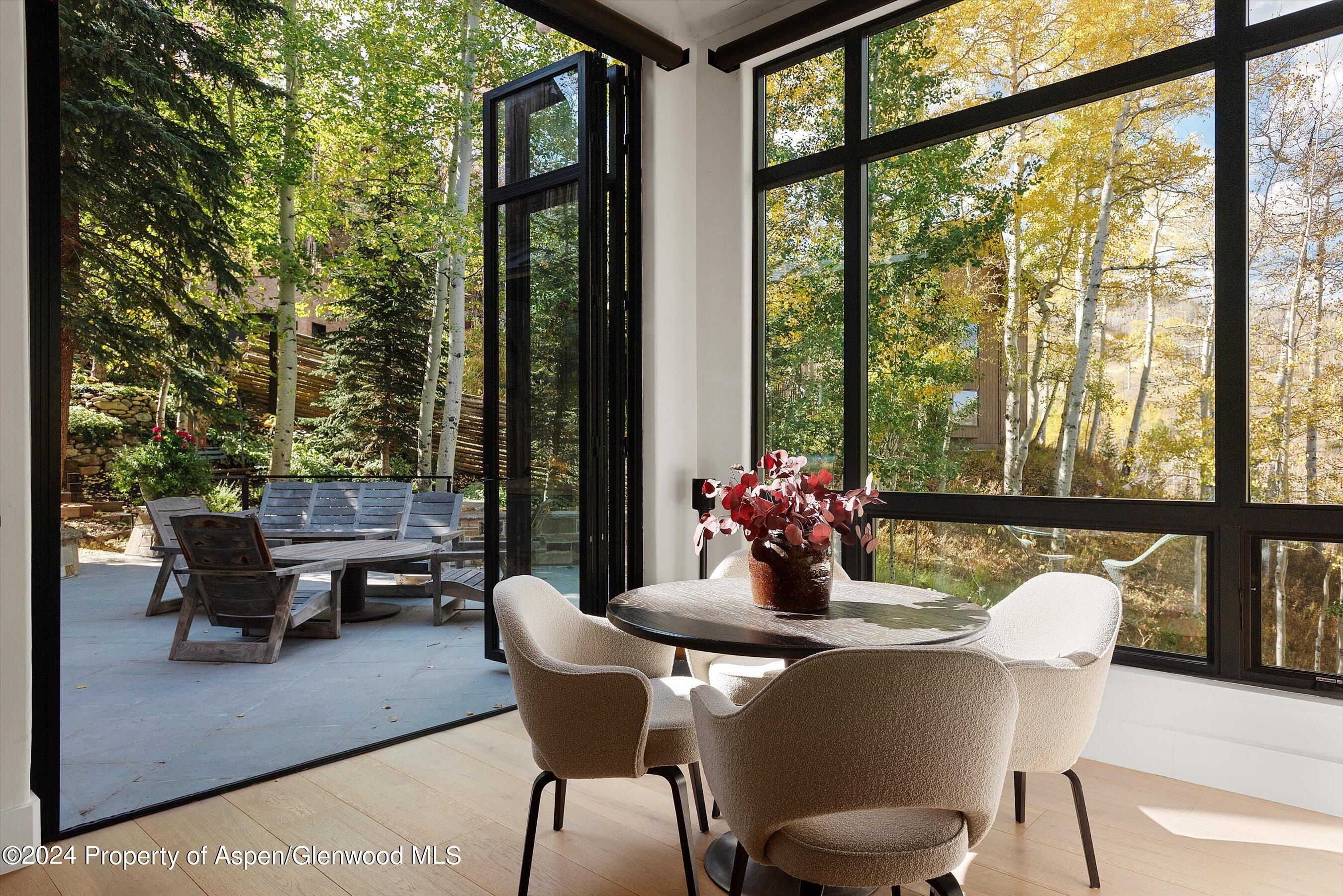 234 Bridge Lane Snowmass Village, CO 81615 - Photo 6 of 46 a dining room with furniture and a floor to ceiling window
