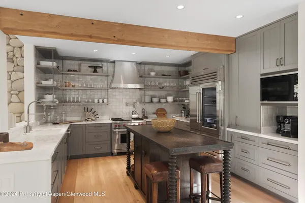 a kitchen with stainless steel appliances granite countertop a sink stove and cabinets