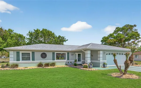 a living room with furniture dining area and a chandelier