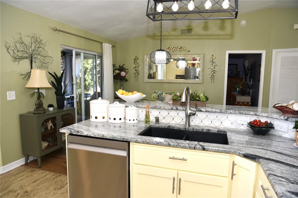 10447 Southwest 62nd Court Ocala, FL 34476 - Photo 15 of 58 a kitchen with kitchen island granite countertop a sink and a stove
