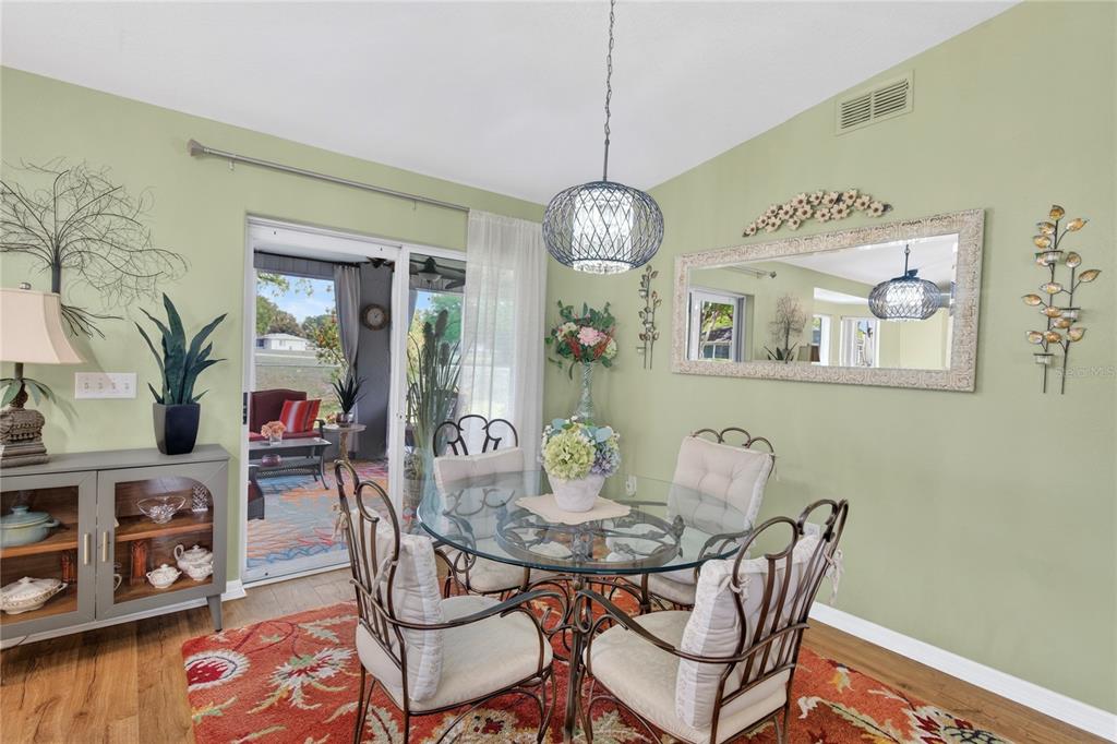 10447 Southwest 62nd Court Ocala, FL 34476 - Photo 19 of 58 a view of a dining room with furniture and wooden floor