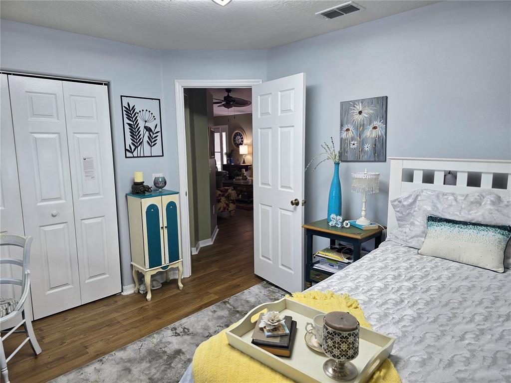 10447 Southwest 62nd Court Ocala, FL 34476 - Photo 22 of 58 a bedroom with furniture and a wooden floor