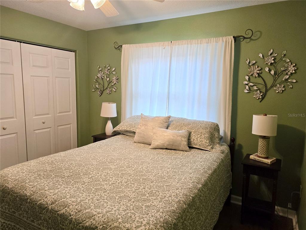 10447 Southwest 62nd Court Ocala, FL 34476 - Photo 24 of 58 a bedroom with a bed and a lamp