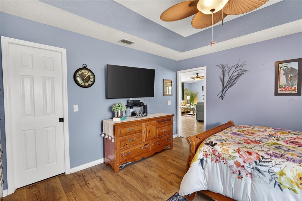10447 Southwest 62nd Court Ocala, FL 34476 - Photo 32 of 58 a bedroom with furniture and a flat screen tv