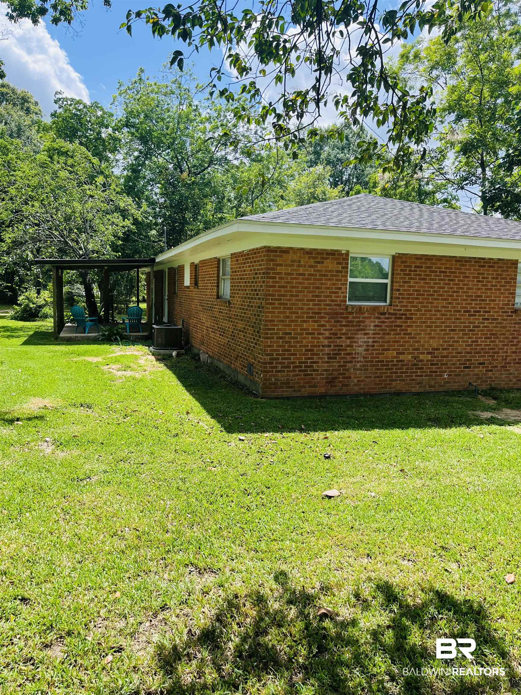 16799 Hinote Glass Road Loxley, AL 36551 - Photo 23 of 26 View of property exterior with a lawn, cooling unit, and brick siding