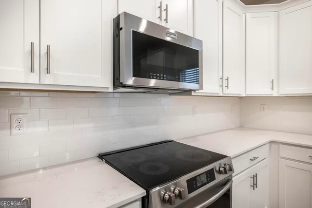 a kitchen with a stove and a microwave