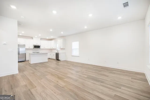 a view of kitchen with wooden floor and windows