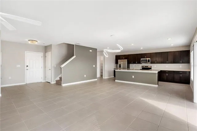 a view of kitchen with a sink and cabinets