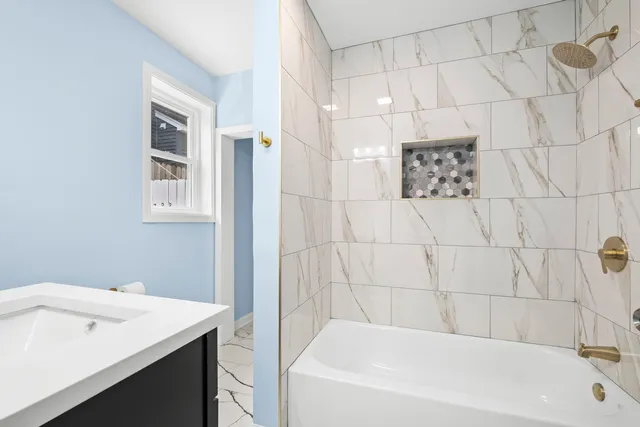 a bathroom with a bathtub and shower