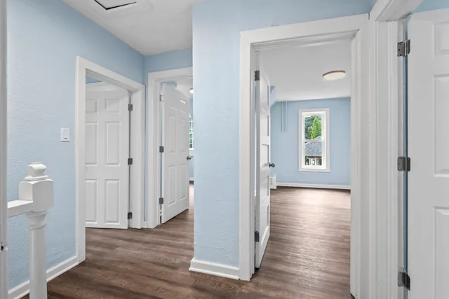 a view of a hallway with wooden floor
