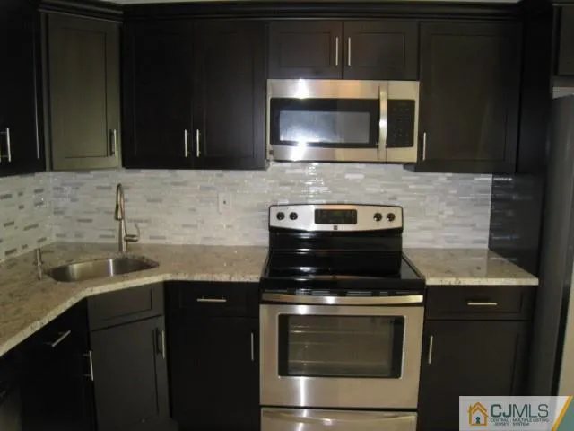 a kitchen with a sink stove and microwave