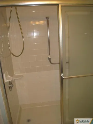 a bathroom with a glass shower door