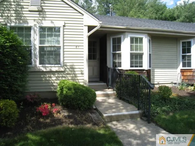 a view of a house with potted plants