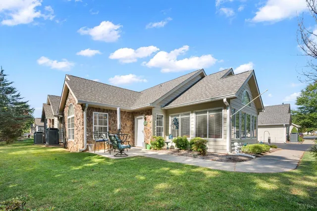 a view of a house with backyard porch and sitting area