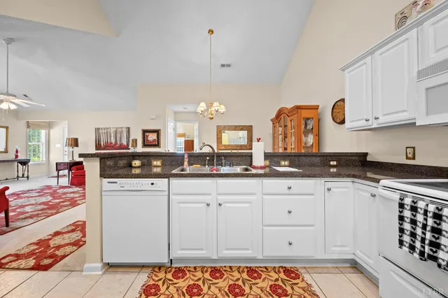 a kitchen with stainless steel appliances granite countertop a sink and cabinets