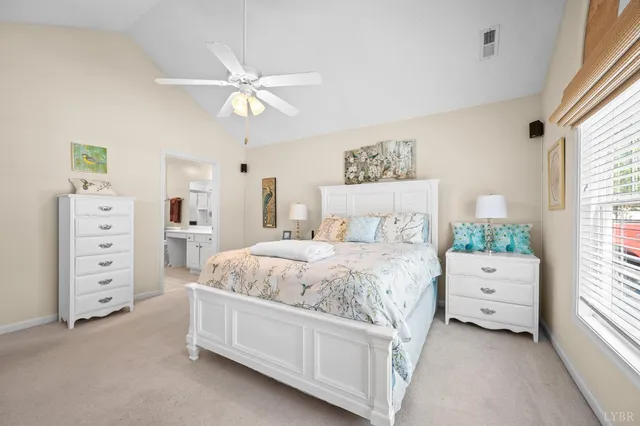 a spacious bedroom with a bed and a window