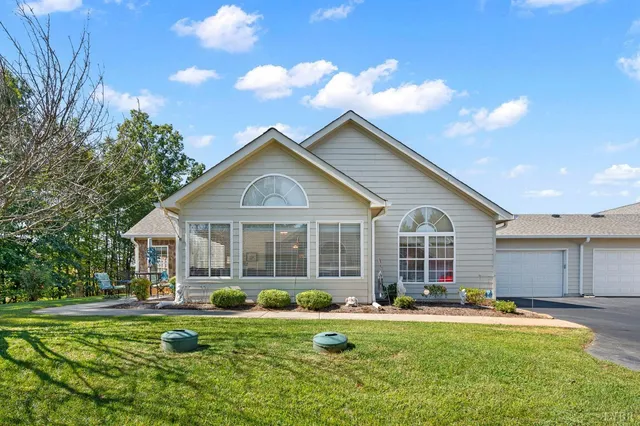 a front view of a house with a garden and porch