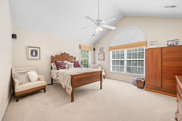 a spacious bedroom with a bed and a couch