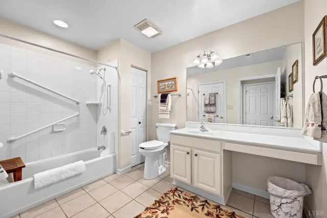 a spacious bathroom with a double vanity sink toilet mirror and a bathtub
