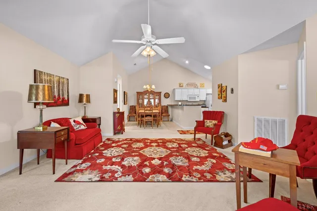 a living room with furniture a rug and white walls