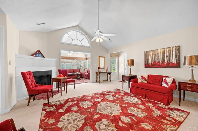 a living room with furniture a fireplace and a chandelier