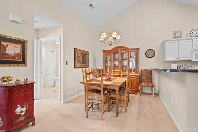 a view of a dining room with furniture and chandelier
