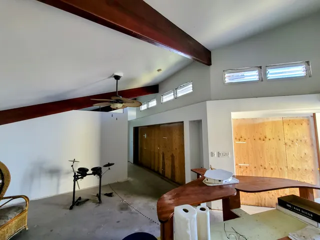 a room with furniture pool table and window