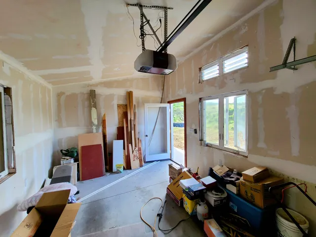 a living room with furniture chess floor and large window