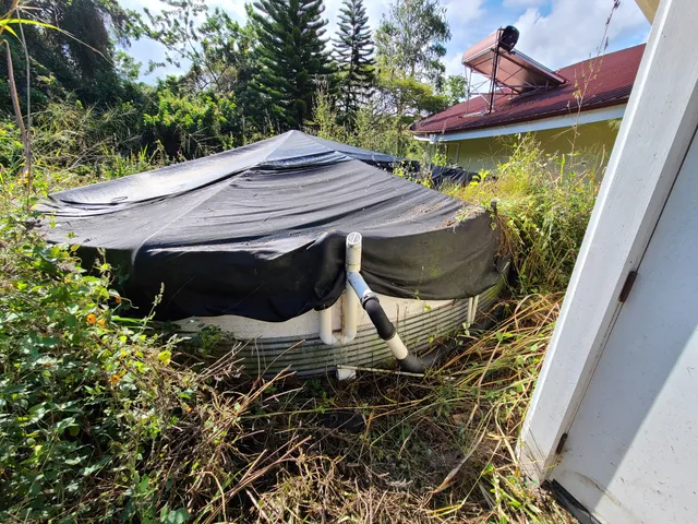 a roof deck with table and chairs and potted plants