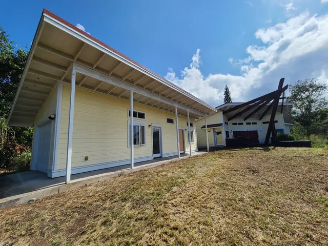 a front view of a house with a big yard