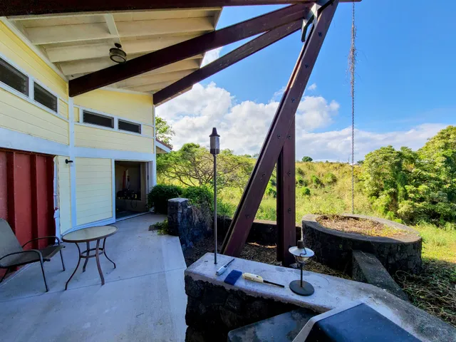 a view of a workspace with furniture and a potted plant