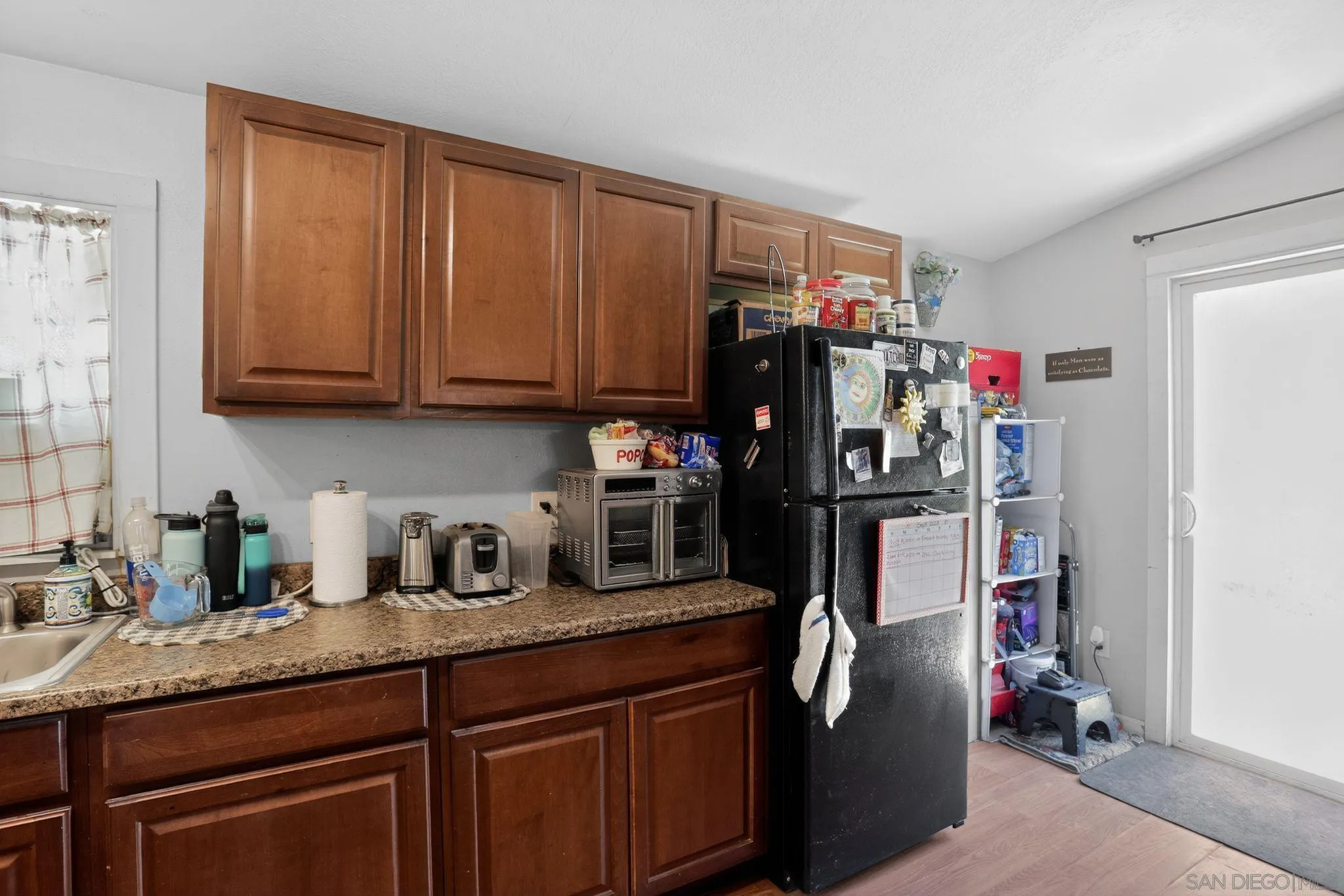16522 Stagecoach Road Corning, CA 96021 - Photo 12 of 30 a kitchen with refrigerator and cabinets