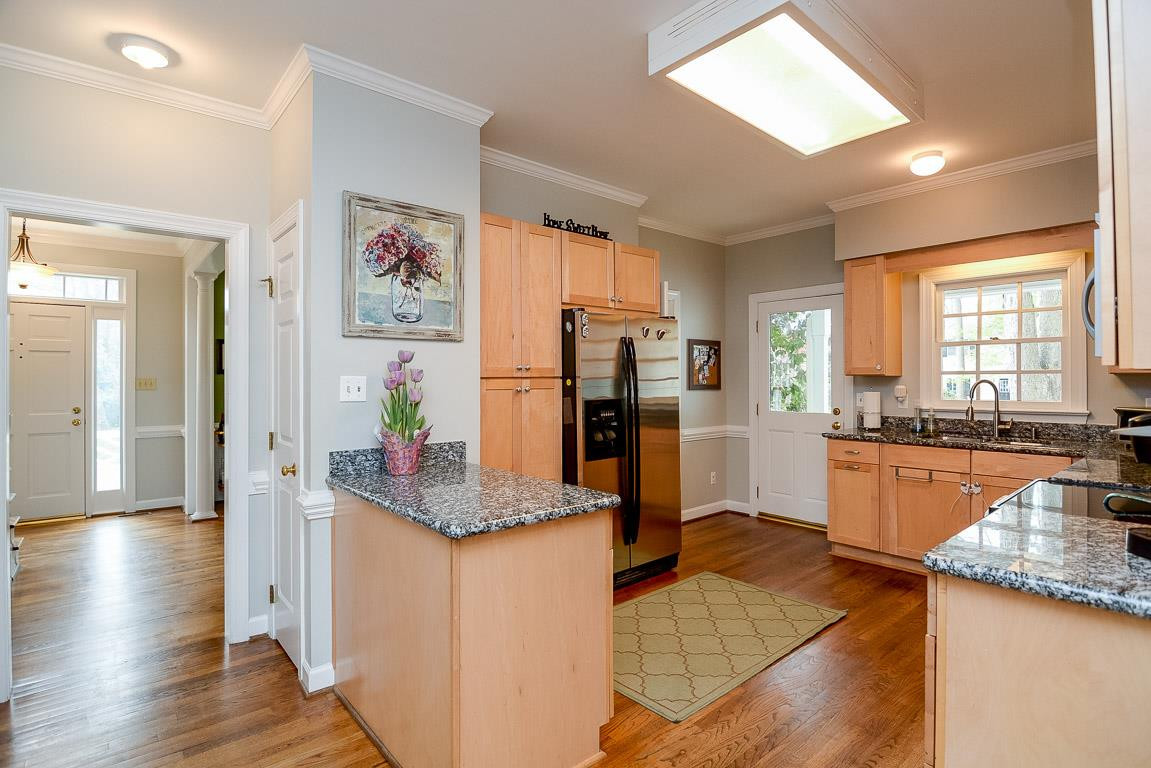 Updated with granite counters and stainless steel appliances. Easy access to the deck and patio for outdoor entertaining. Open and Bright Kitchen