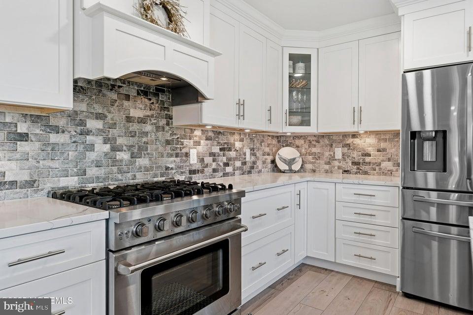 1210 Skimmer Court Forked River, NJ 08731 - Photo 13 of 66 a kitchen with stainless steel appliances granite countertop a stove and a refrigerator