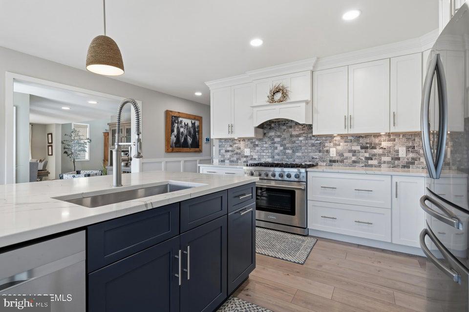 1210 Skimmer Court Forked River, NJ 08731 - Photo 14 of 66 a kitchen with stainless steel appliances granite countertop a stove a sink and a refrigerator