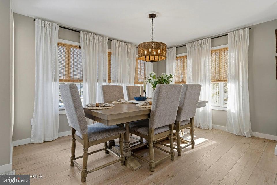 1210 Skimmer Court Forked River, NJ 08731 - Photo 17 of 66 a view of a dining room with furniture window and wooden floor