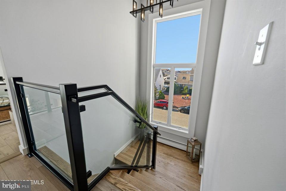 1210 Skimmer Court Forked River, NJ 08731 - Photo 31 of 66 a view of a hallway with wooden floor and staircase