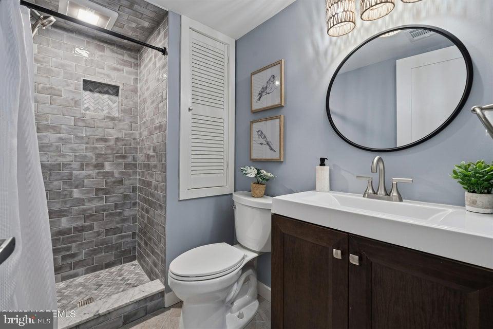 1210 Skimmer Court Forked River, NJ 08731 - Photo 37 of 66 a bathroom with a sink mirror vanity and toilet