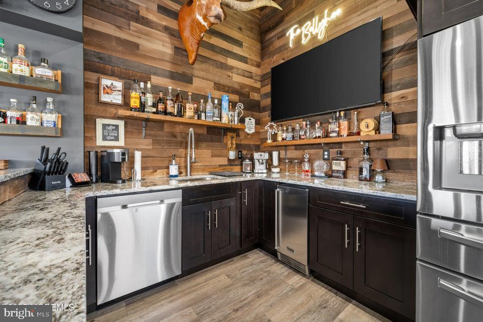1210 Skimmer Court Forked River, NJ 08731 - Photo 47 of 66 a kitchen with stainless steel appliances granite countertop a sink and wooden cabinets