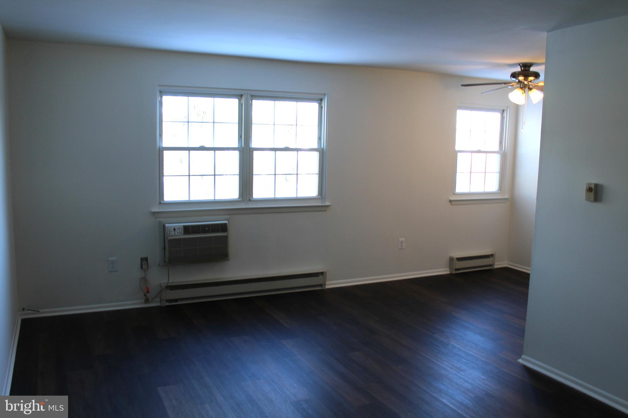 178 Elephant Road, Unit A6 Dublin, PA 18917 - Photo 3 of 19 an empty room with wooden floor and windows