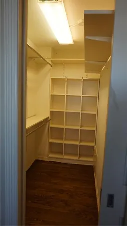 a view of walk in closet with empty racks