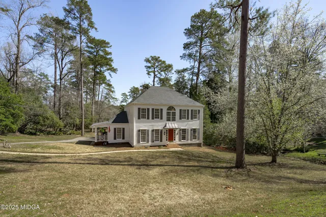 a view of a house with a large trees