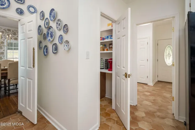 a dining room with furniture potted plants and wooden floor
